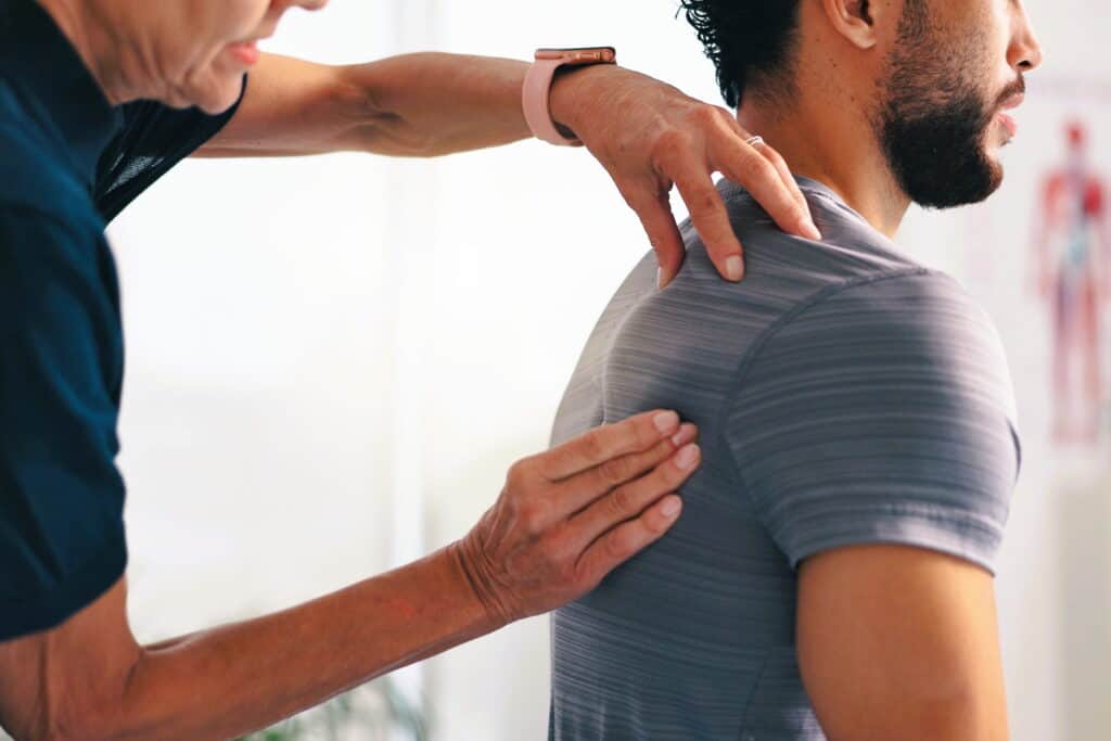 man-receiving-a-shoulder-examination-by-a-chiropractor